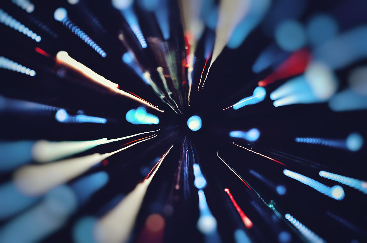 who-we-are Vibrant abstract light trails captured with long exposure, creating a colorful dynamic effect.